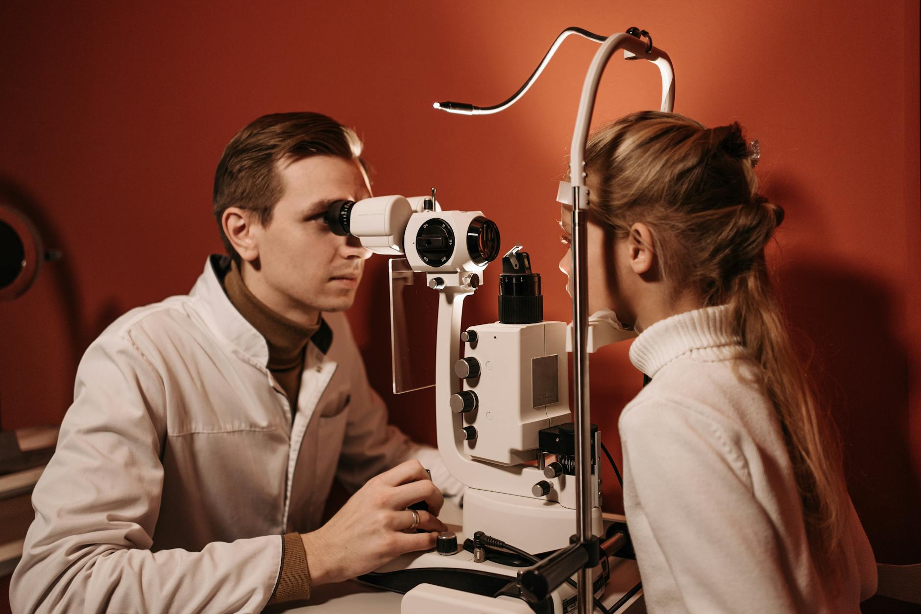 an ophthalmologist examining a girl s eye